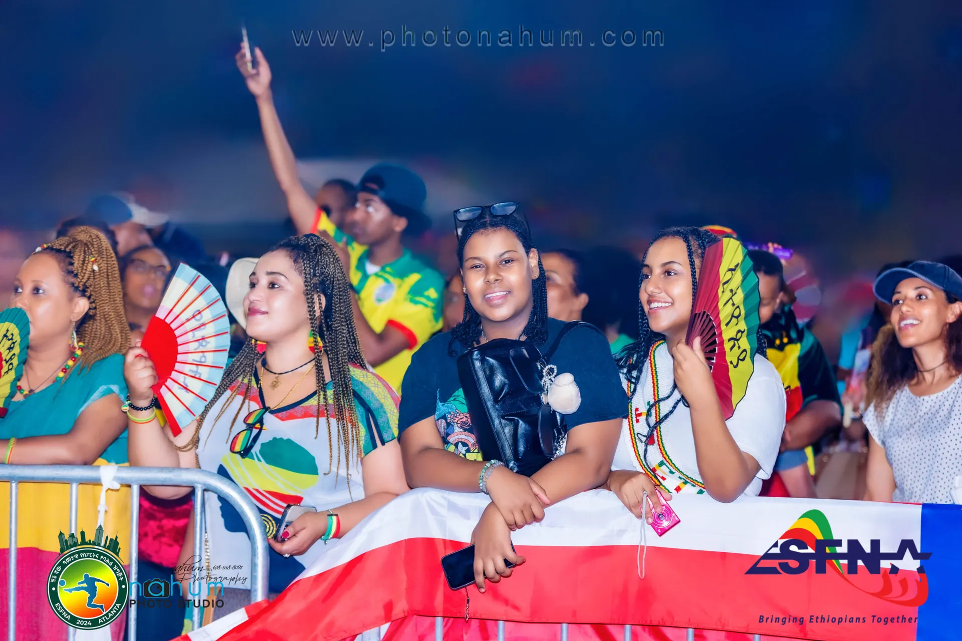 Fans in Ethiopian colours cheering at the barrier